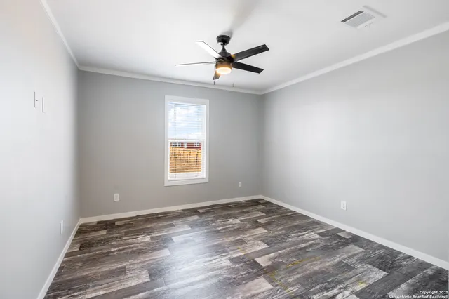 wooden floor in an empty room with a window