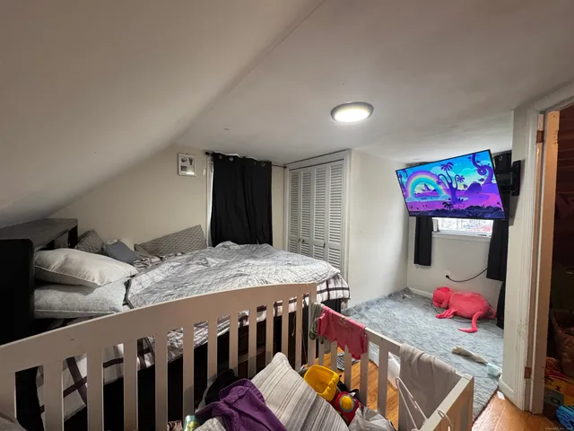 a bedroom with furniture and a baby crib