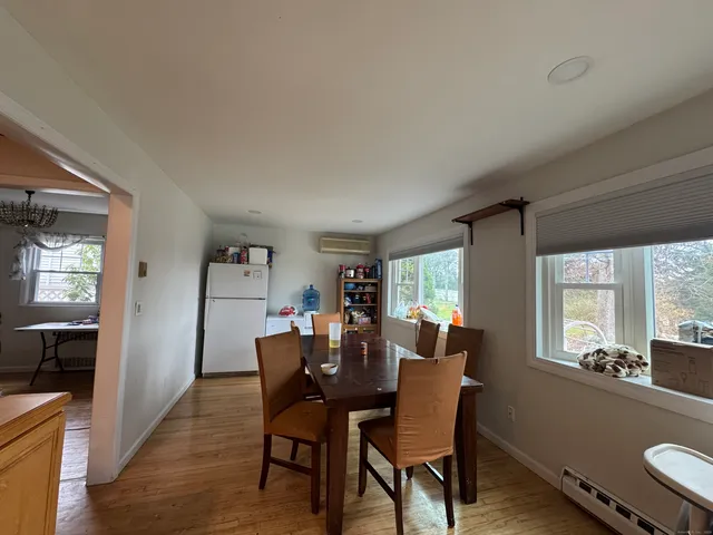 a view of a dining room with furniture and window