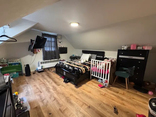 a bedroom with furniture and a flat screen tv