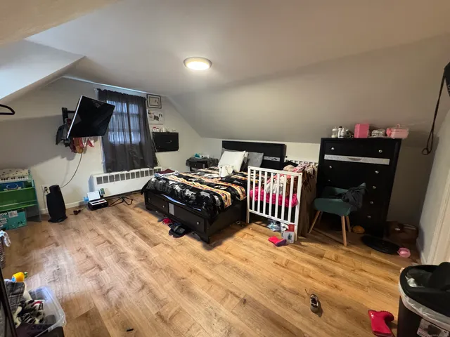 a bedroom with furniture and a window