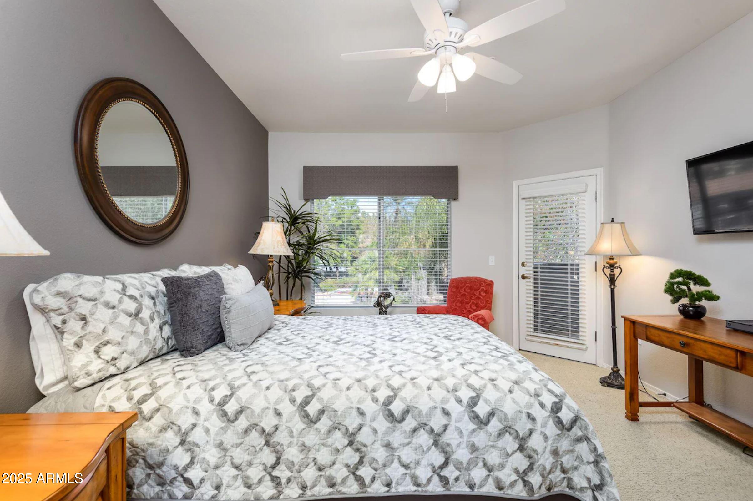 600 West Grove Parkway Tempe, AZ 85283 - Photo 12 of 23 a bedroom with a large bed and a chandelier