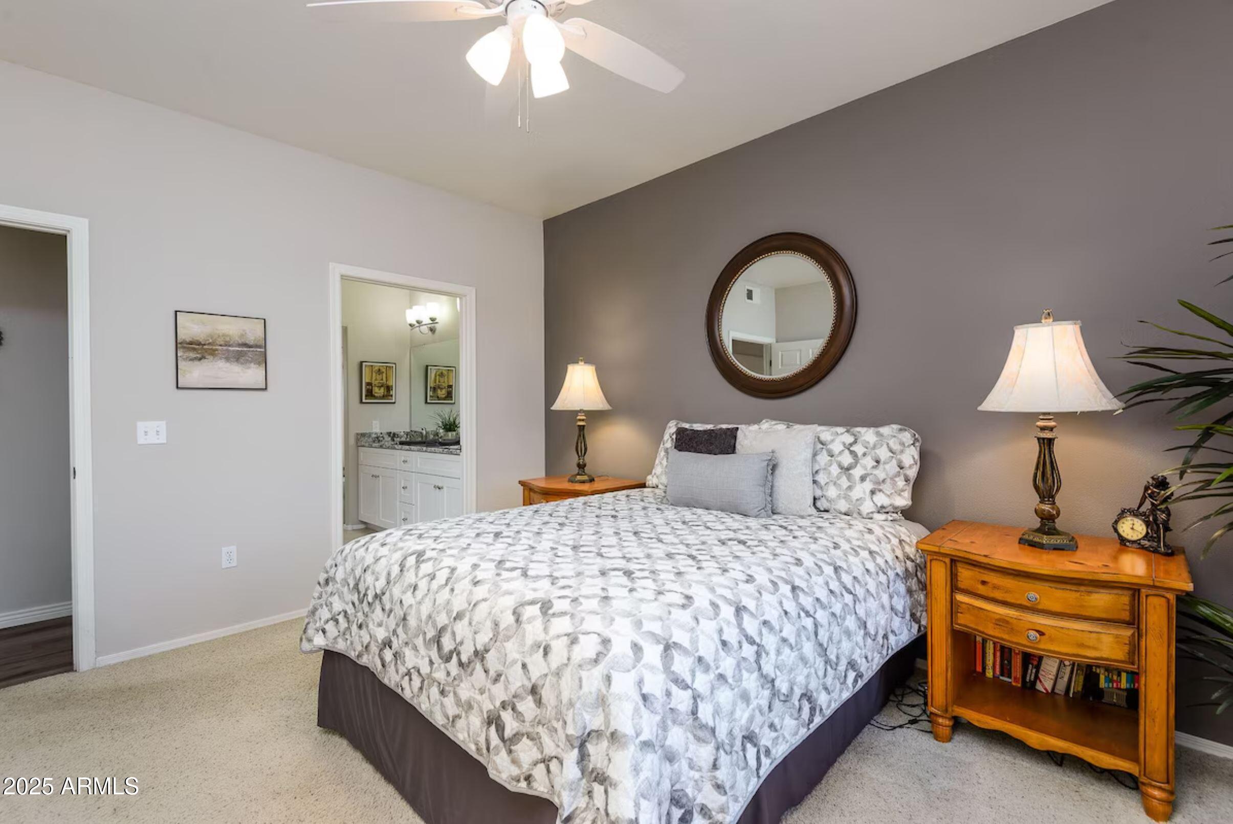 600 West Grove Parkway Tempe, AZ 85283 - Photo 13 of 23 a bedroom with a bed a lamp and a chandelier