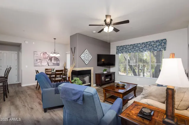 a living room with furniture a flat screen tv and a window