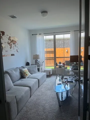 a living room with furniture and a large window