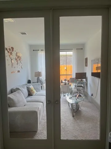 a living room with furniture and a large window