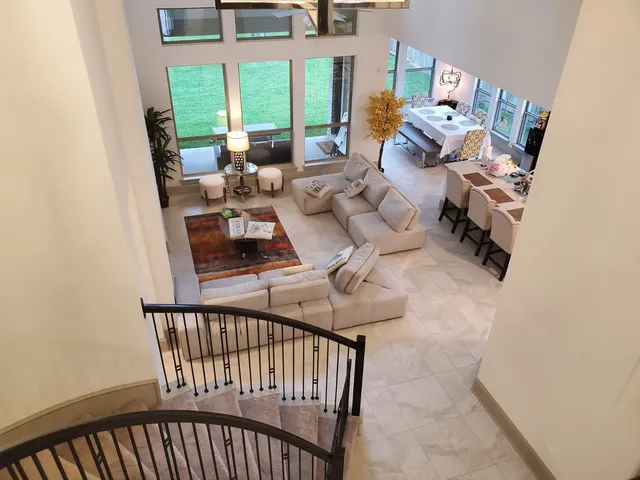 a view of a workspace with furniture and a window