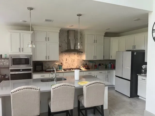 a kitchen with refrigerator and cabinets