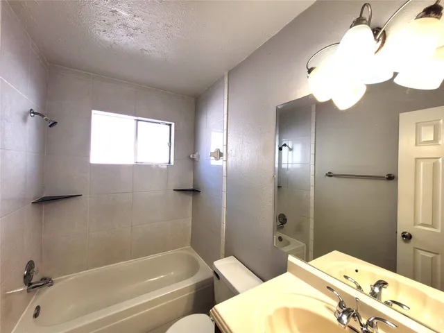 a bathroom with a tub and sink