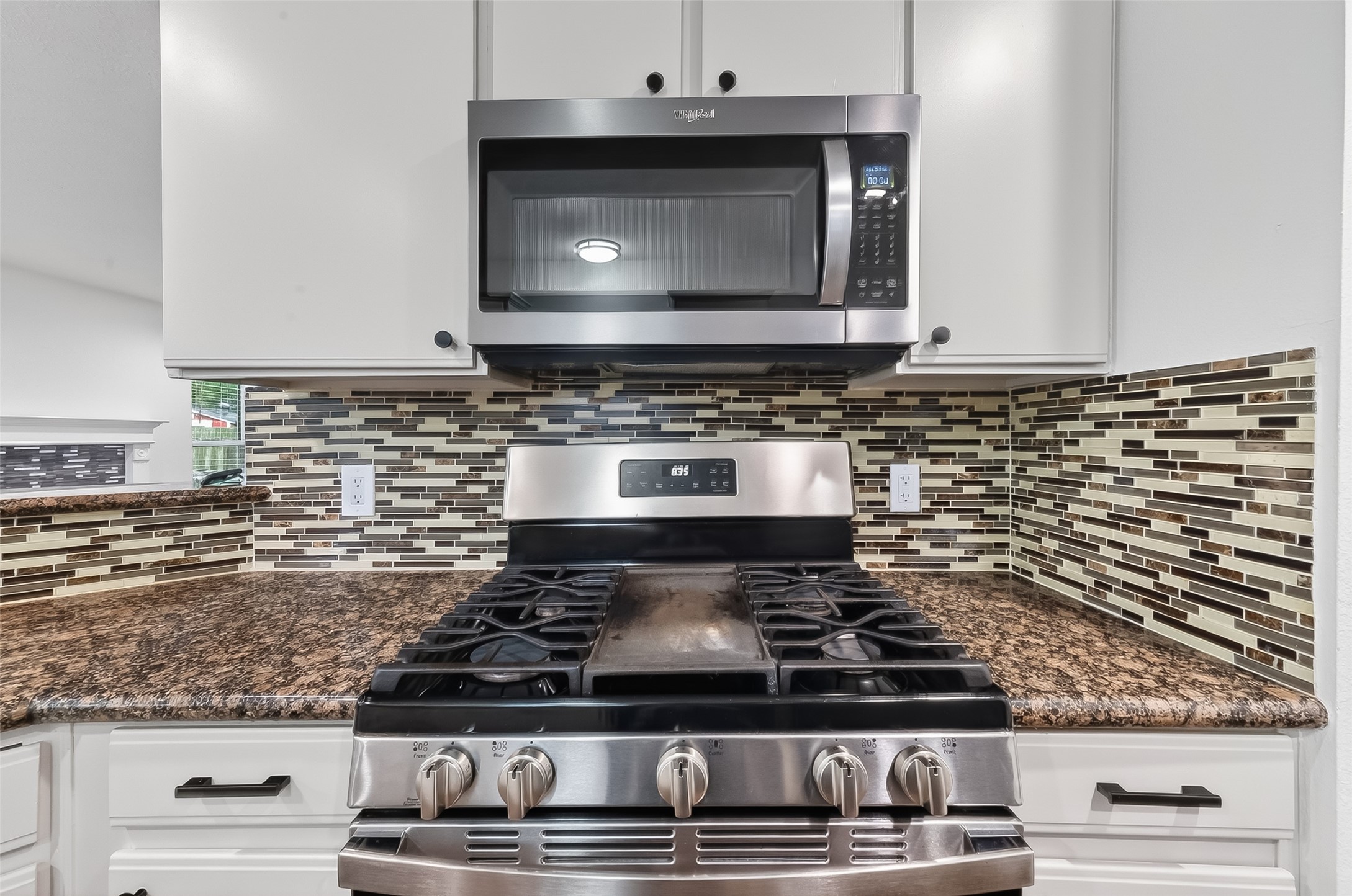 2018 Village Ct Lane Rosenberg, TX 77471 - Photo 13 of 50 a kitchen with stove top oven and cabinets