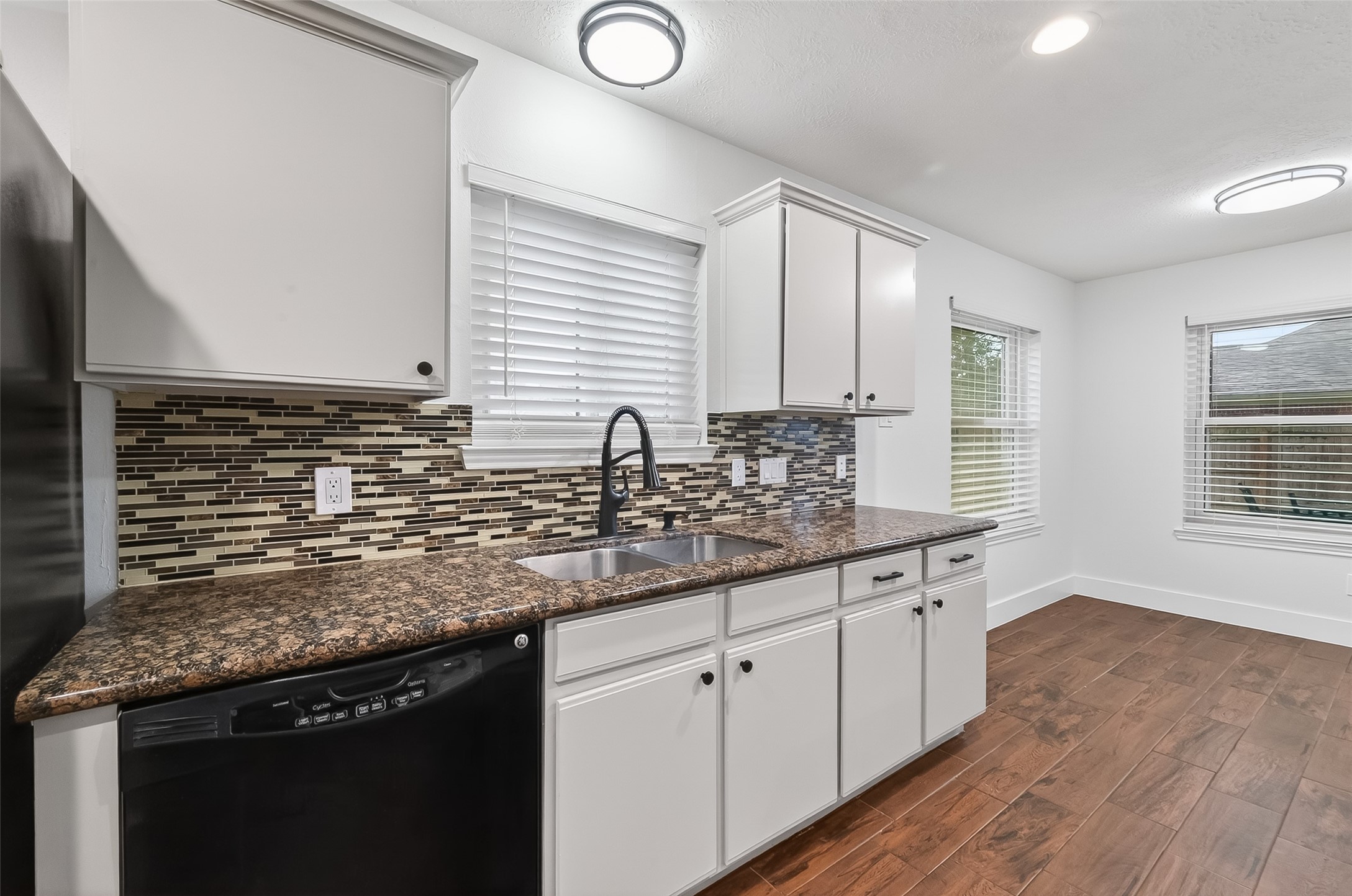 2018 Village Ct Lane Rosenberg, TX 77471 - Photo 14 of 50 a kitchen with sink cabinets and window