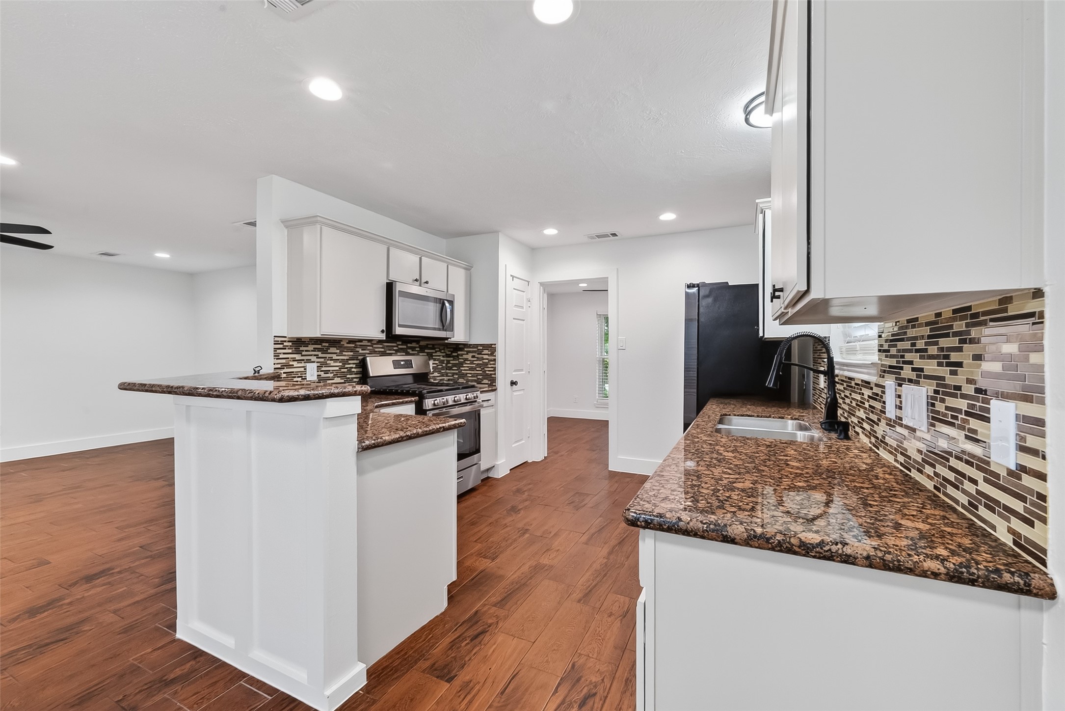 2018 Village Ct Lane Rosenberg, TX 77471 - Photo 18 of 50 a kitchen with stainless steel appliances granite countertop a sink stove and refrigerator