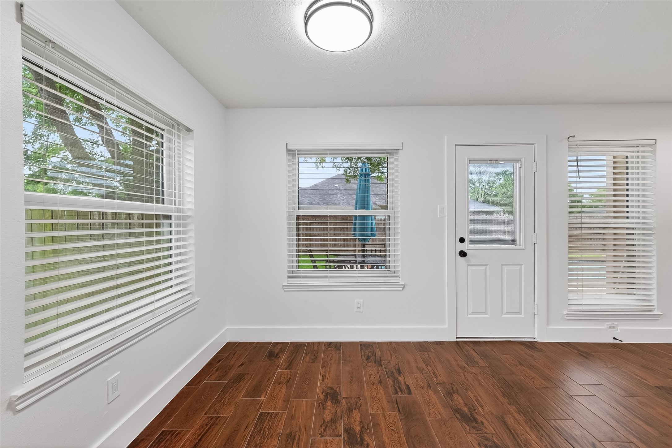 2018 Village Ct Lane Rosenberg, TX 77471 - Photo 20 of 50 a view of an empty room with wooden floor and a window