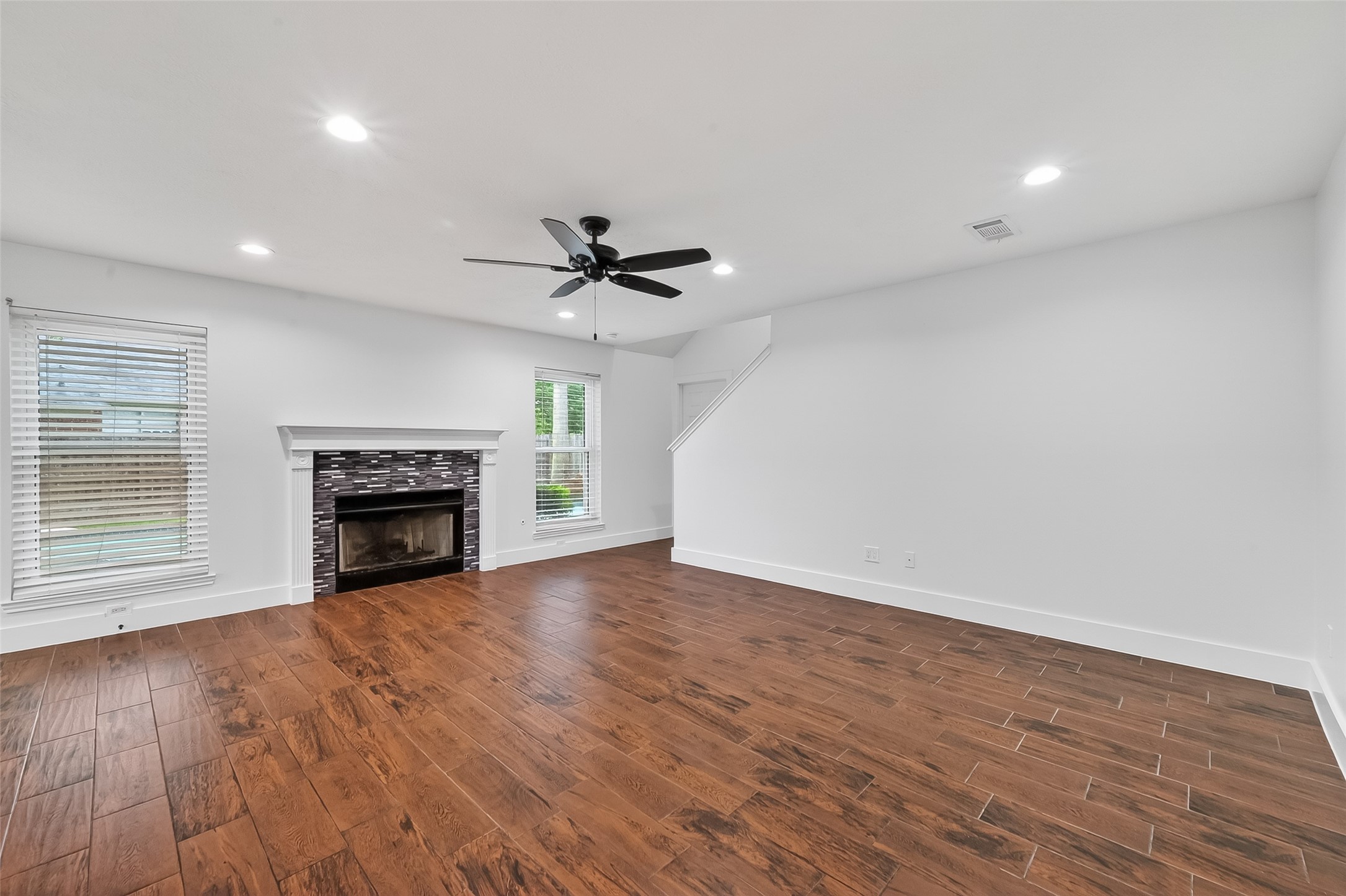 2018 Village Ct Lane Rosenberg, TX 77471 - Photo 22 of 50 a view of an empty room with wooden floor fireplace and a window