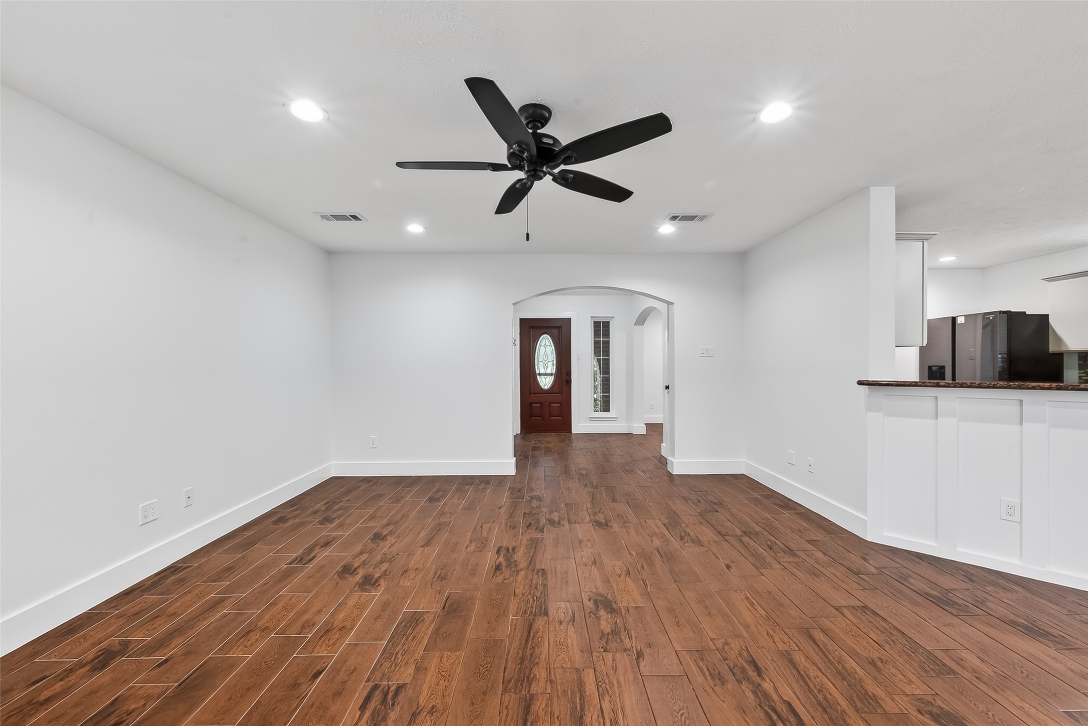2018 Village Ct Lane Rosenberg, TX 77471 - Photo 26 of 50 a view of an empty room with wooden floor and a ceiling fan