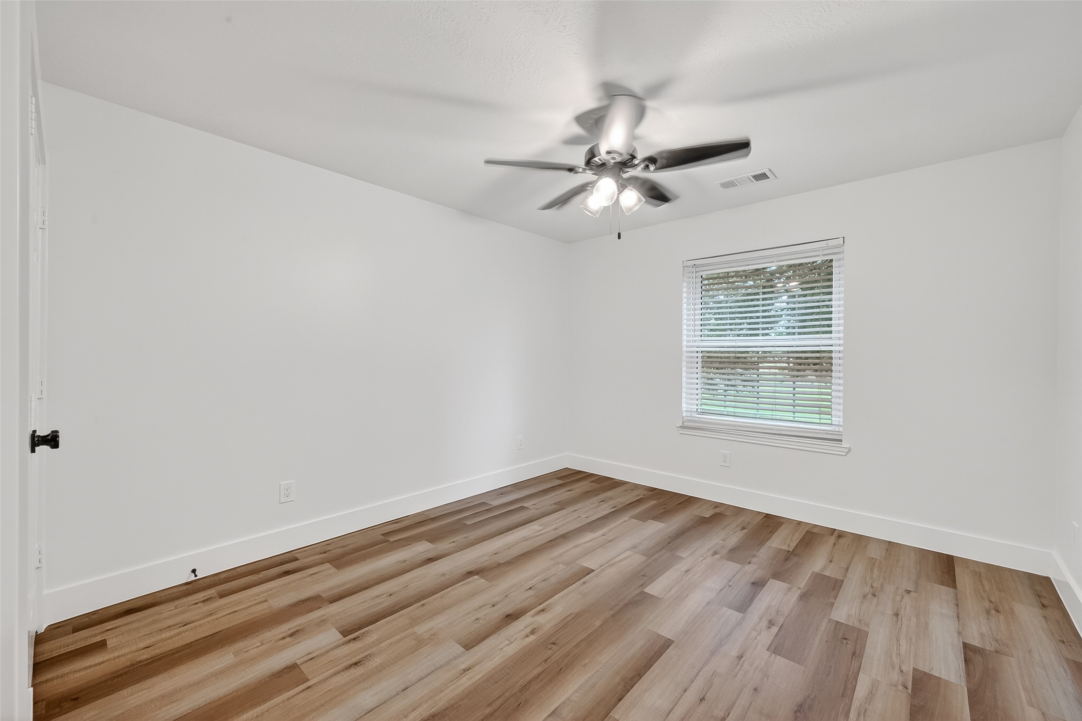 2018 Village Ct Lane Rosenberg, TX 77471 - Photo 28 of 50 a view of empty room with wooden floor and fan