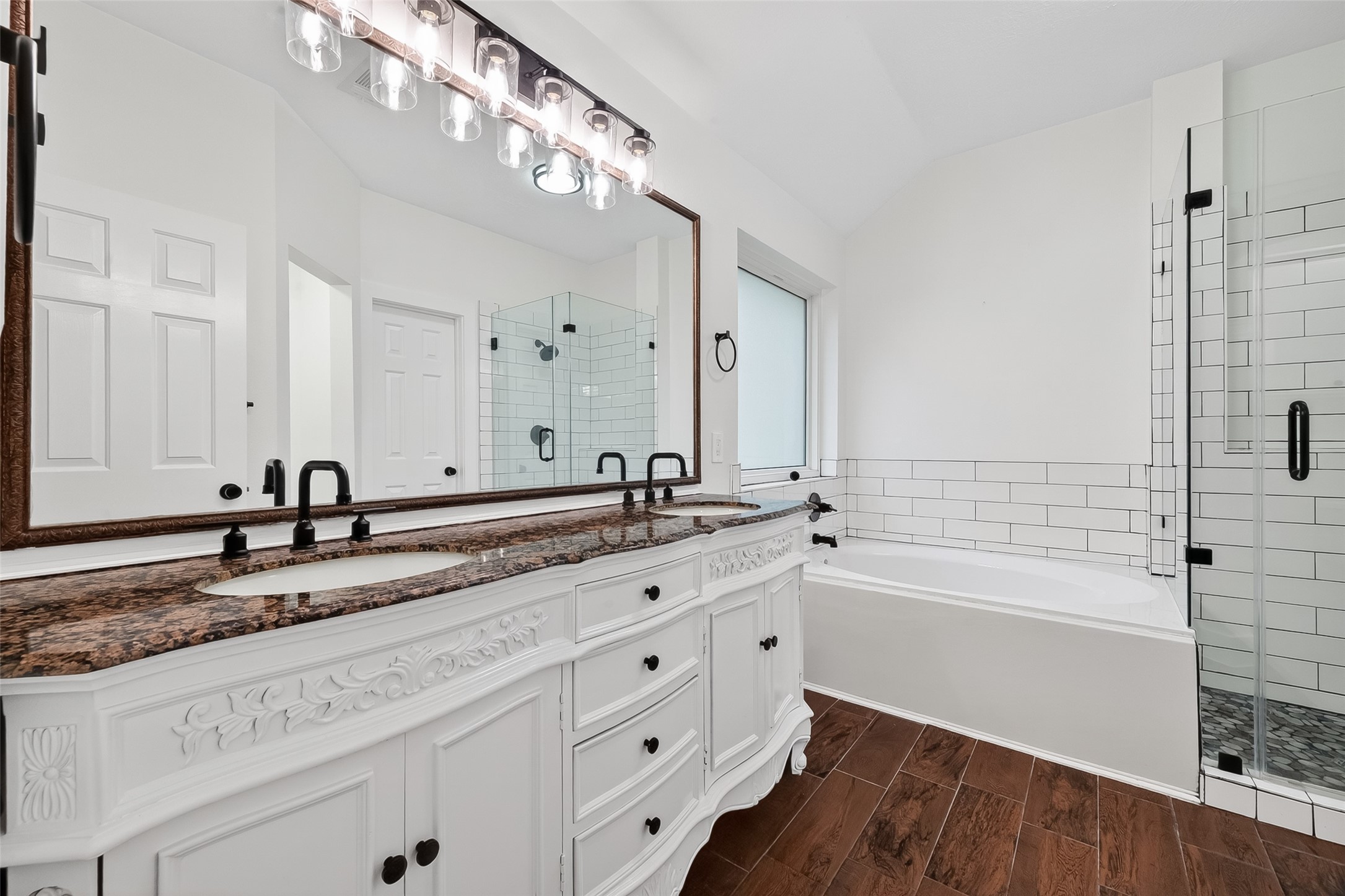2018 Village Ct Lane Rosenberg, TX 77471 - Photo 44 of 50 a bathroom with a granite countertop double vanity sink and mirror with bathtub