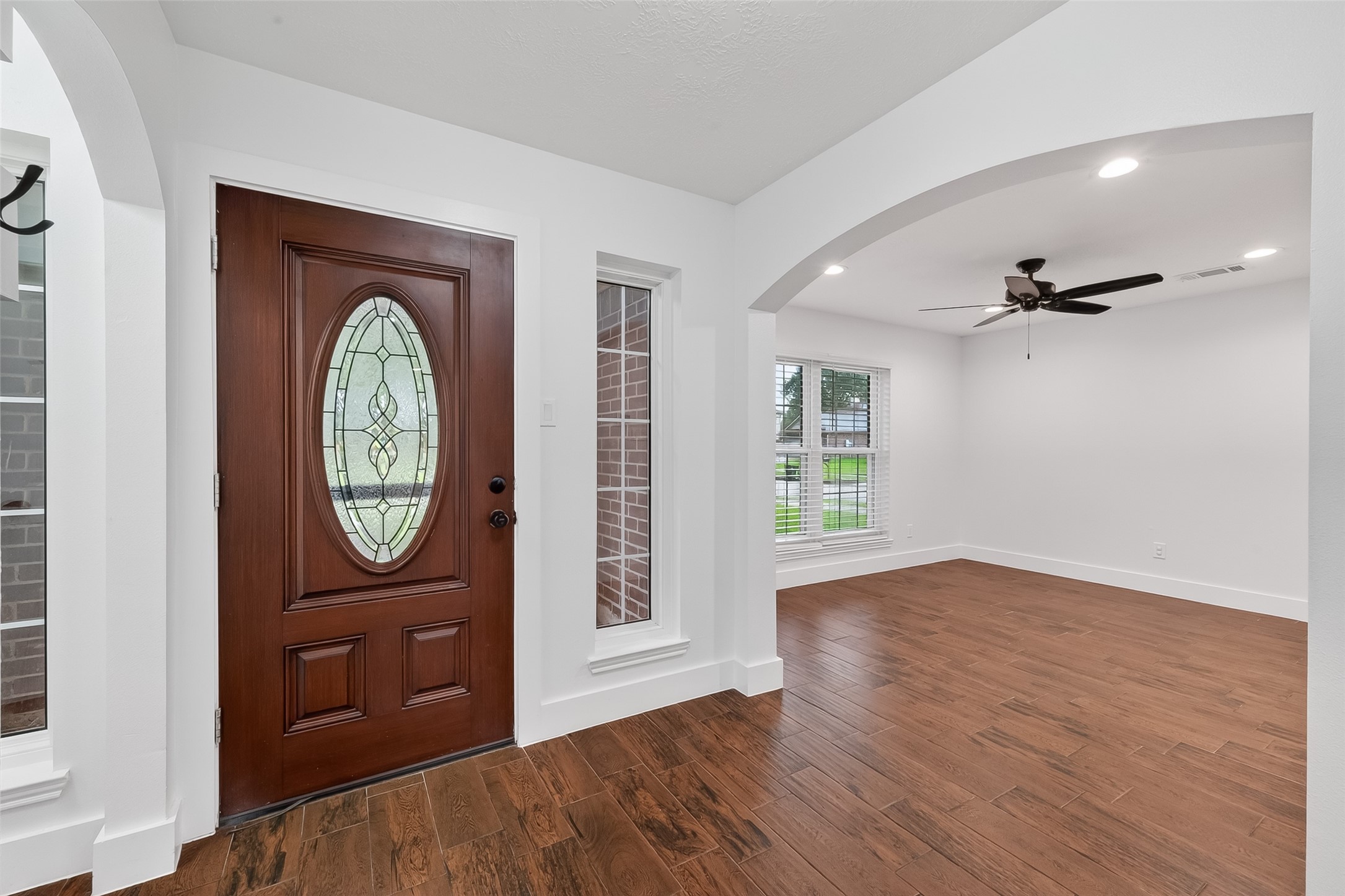 2018 Village Ct Lane Rosenberg, TX 77471 - Photo 7 of 50 an empty room with wooden floor mirror and windows
