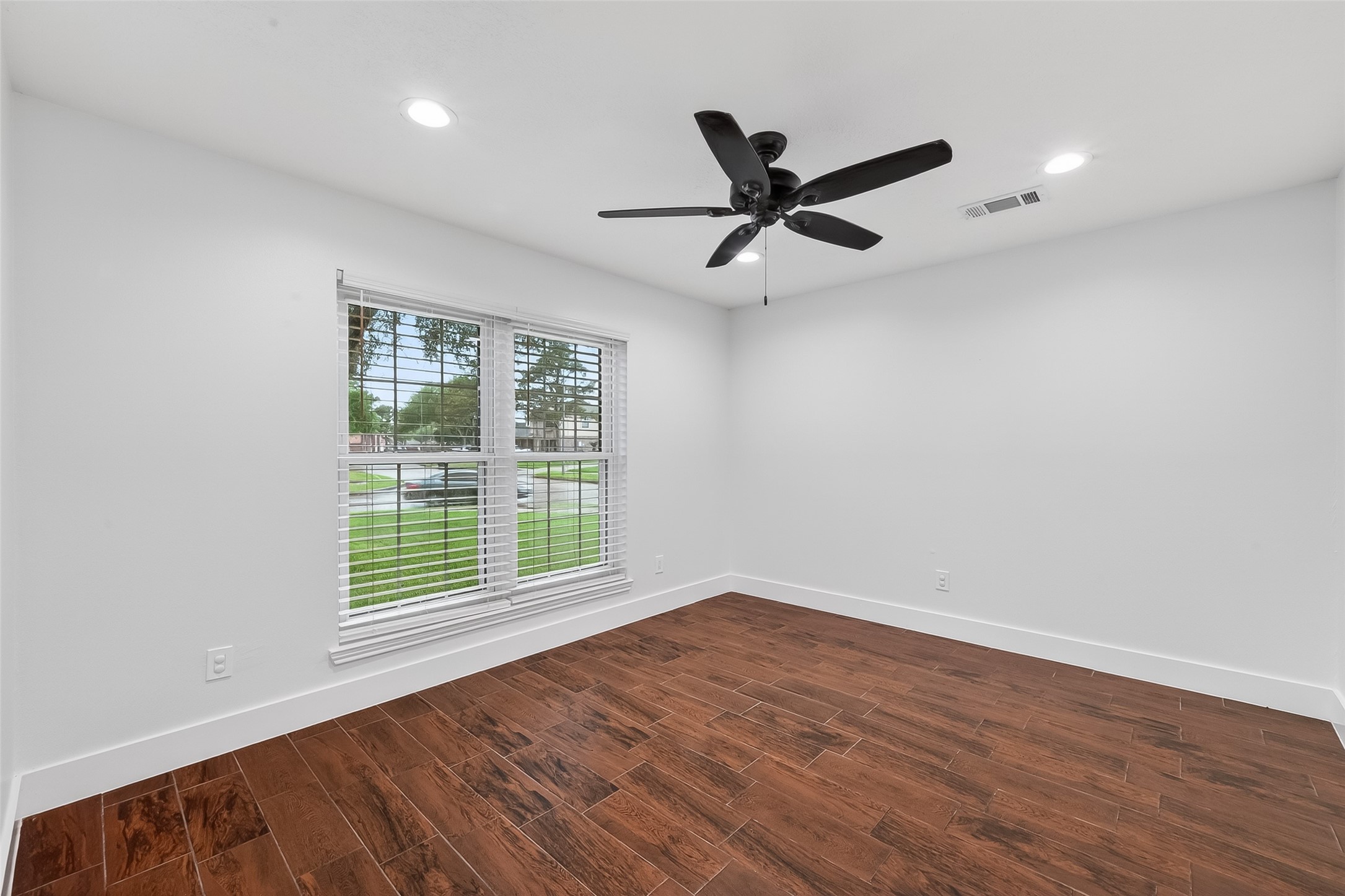 2018 Village Ct Lane Rosenberg, TX 77471 - Photo 9 of 50 wooden floor in an empty room with a window