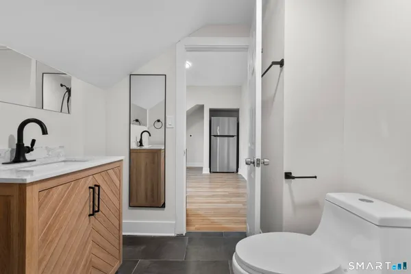 a bathroom with a toilet sink and shower