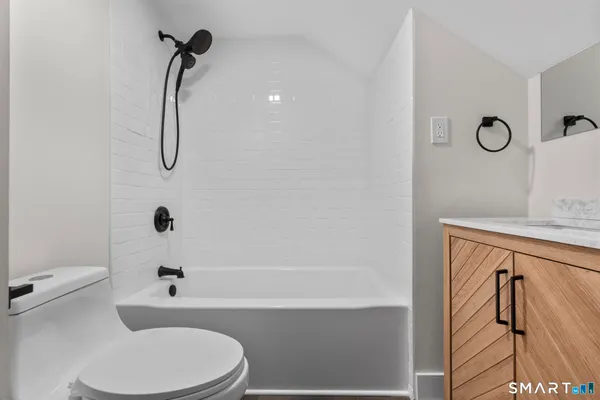 a bathroom with a toilet a sink and bathtub