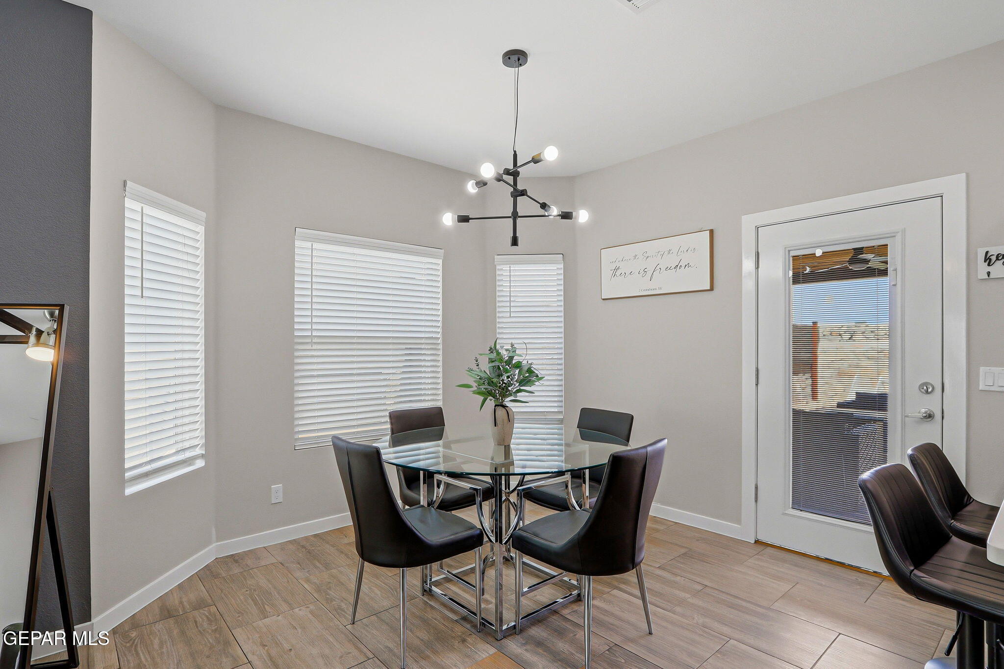 123 Via Rojas Drive Horizon City, TX 79928 - Photo 12 of 47 a dining room with furniture a chandelier and wooden floor
