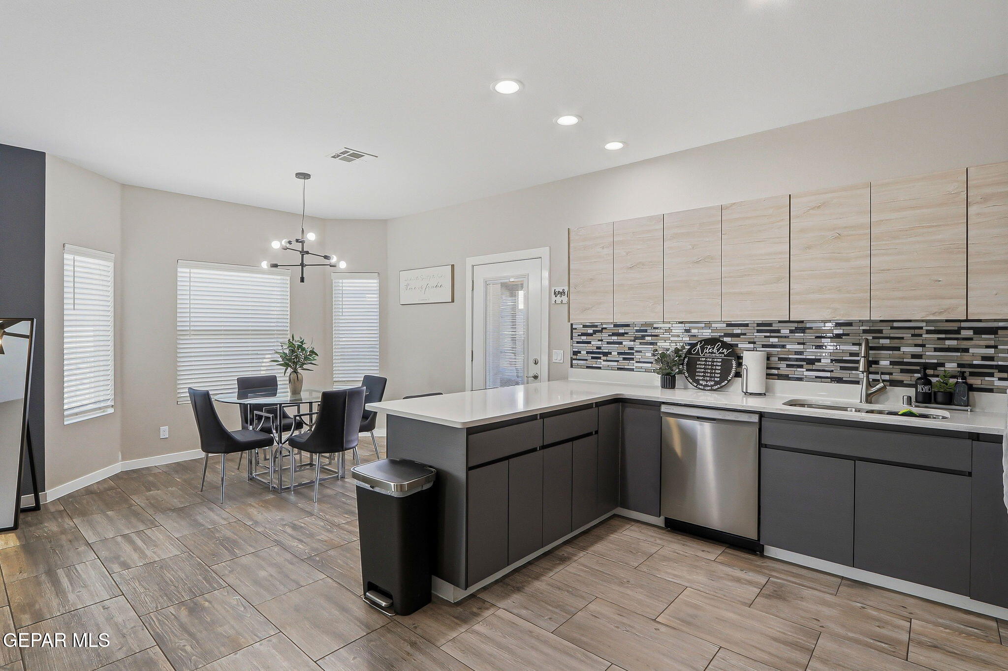 123 Via Rojas Drive Horizon City, TX 79928 - Photo 14 of 47 a kitchen with a sink and chairs