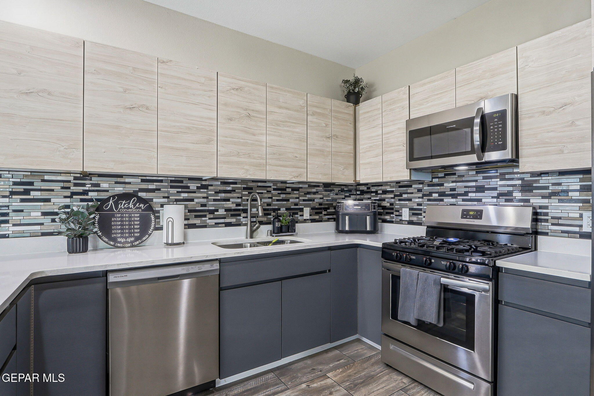123 Via Rojas Drive Horizon City, TX 79928 - Photo 16 of 47 a kitchen with stainless steel appliances a sink stove and cabinets