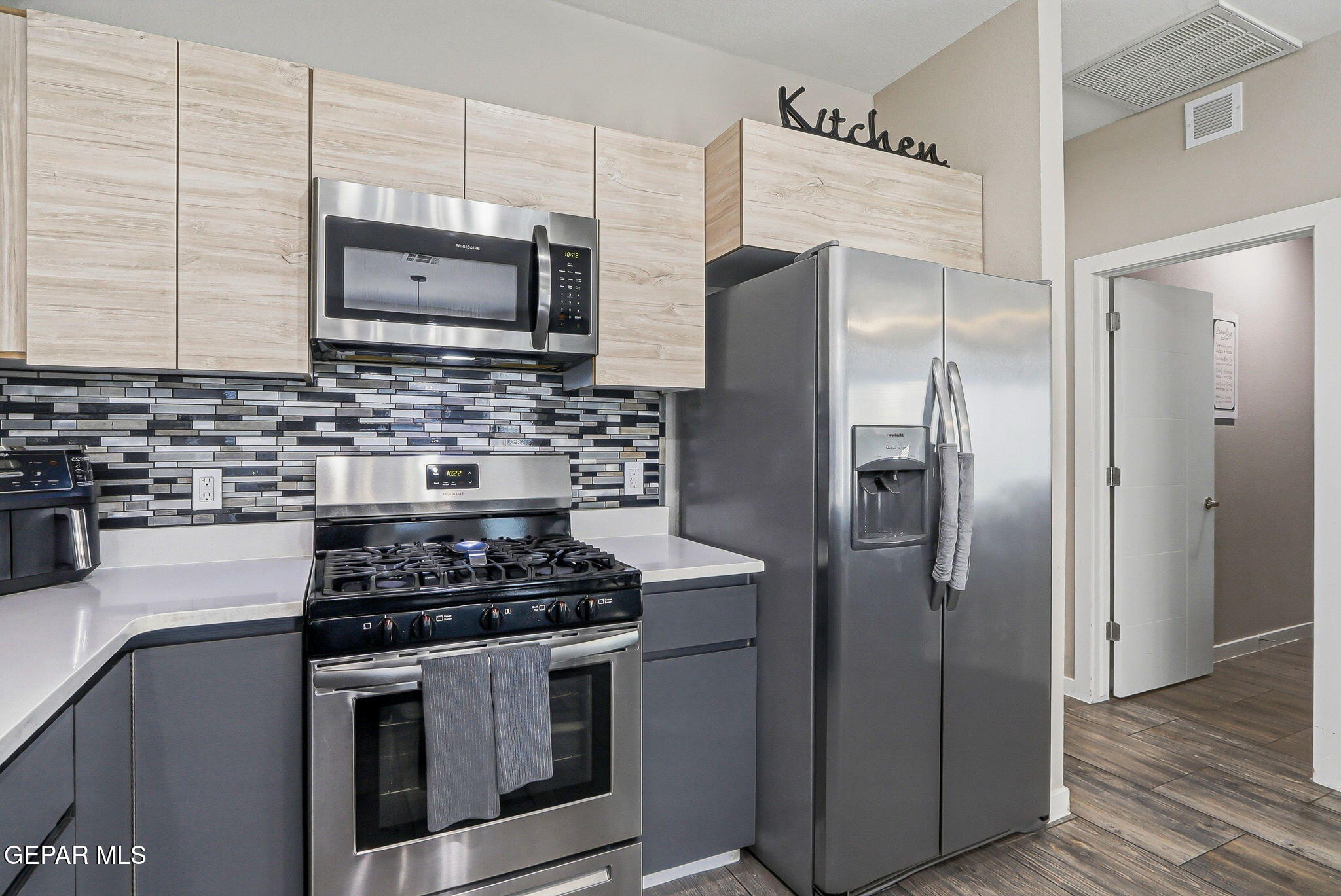 123 Via Rojas Drive Horizon City, TX 79928 - Photo 18 of 47 a kitchen with stainless steel appliances a refrigerator stove and microwave