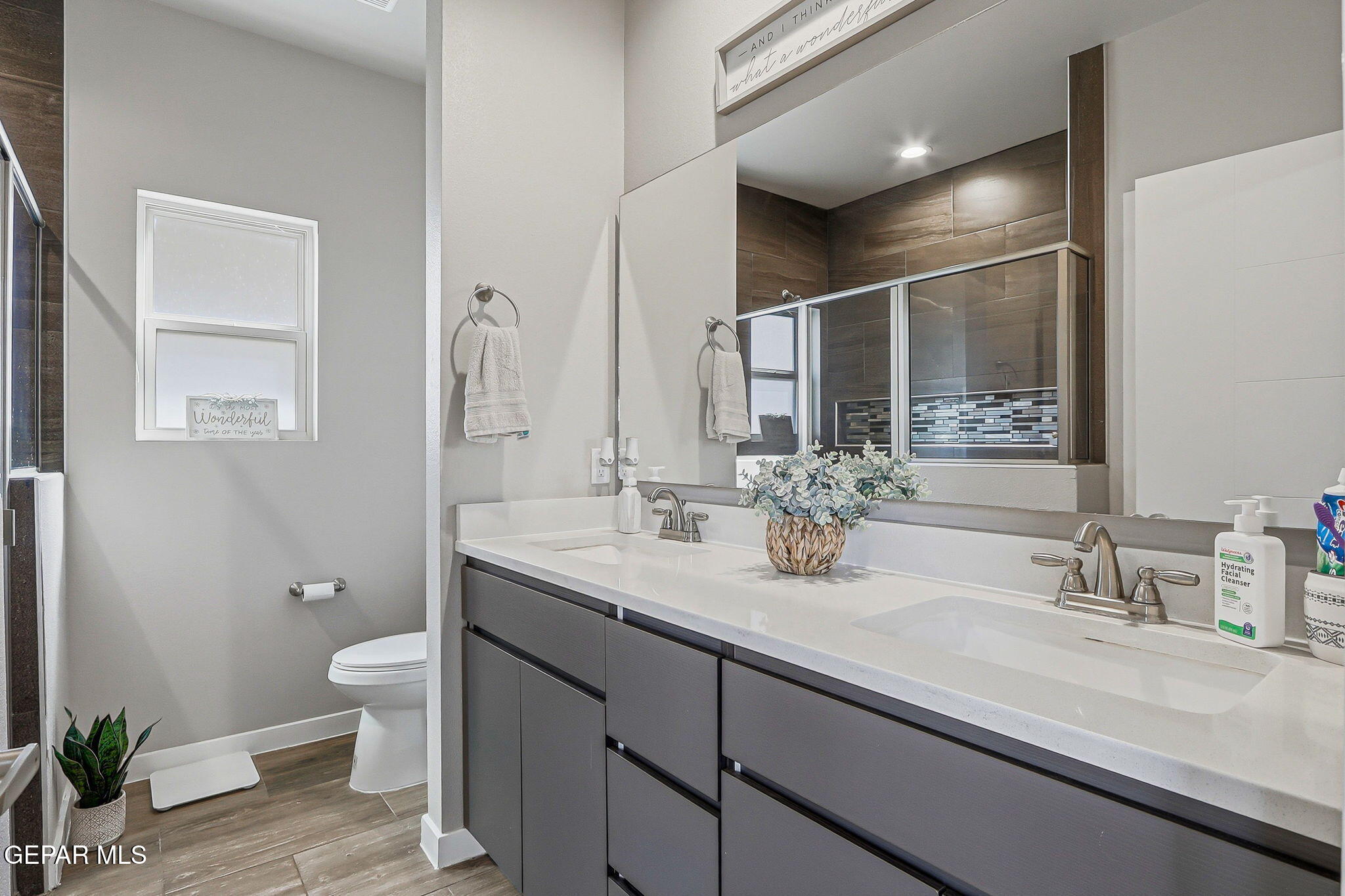 123 Via Rojas Drive Horizon City, TX 79928 - Photo 24 of 47 a bathroom with a double vanity sink toilet and a mirror