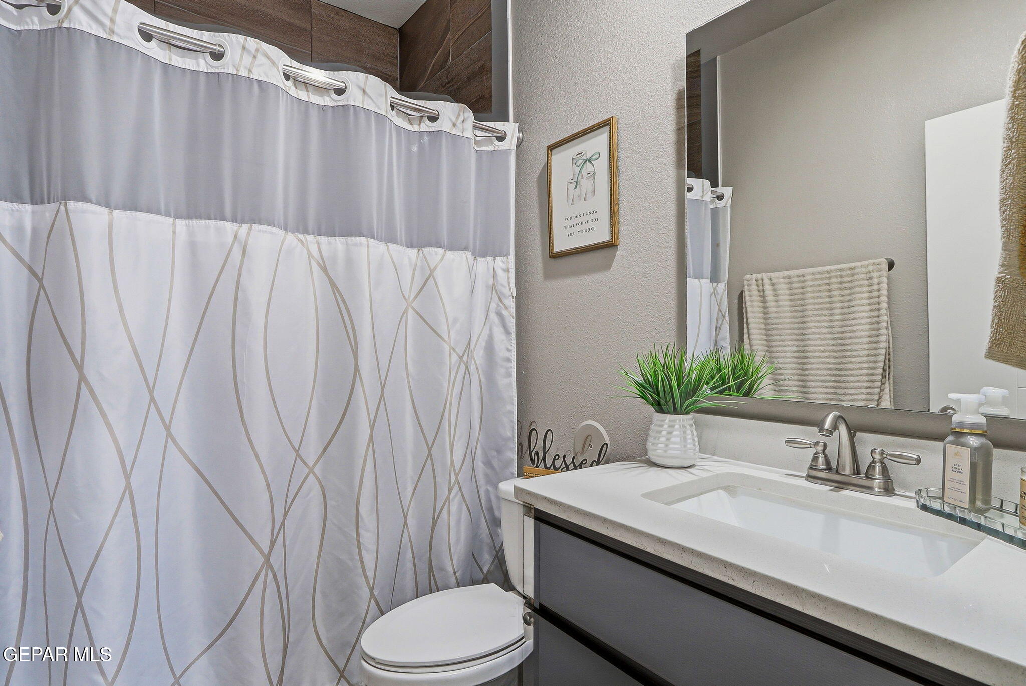 123 Via Rojas Drive Horizon City, TX 79928 - Photo 29 of 47 a bathroom with a granite countertop sink and a mirror