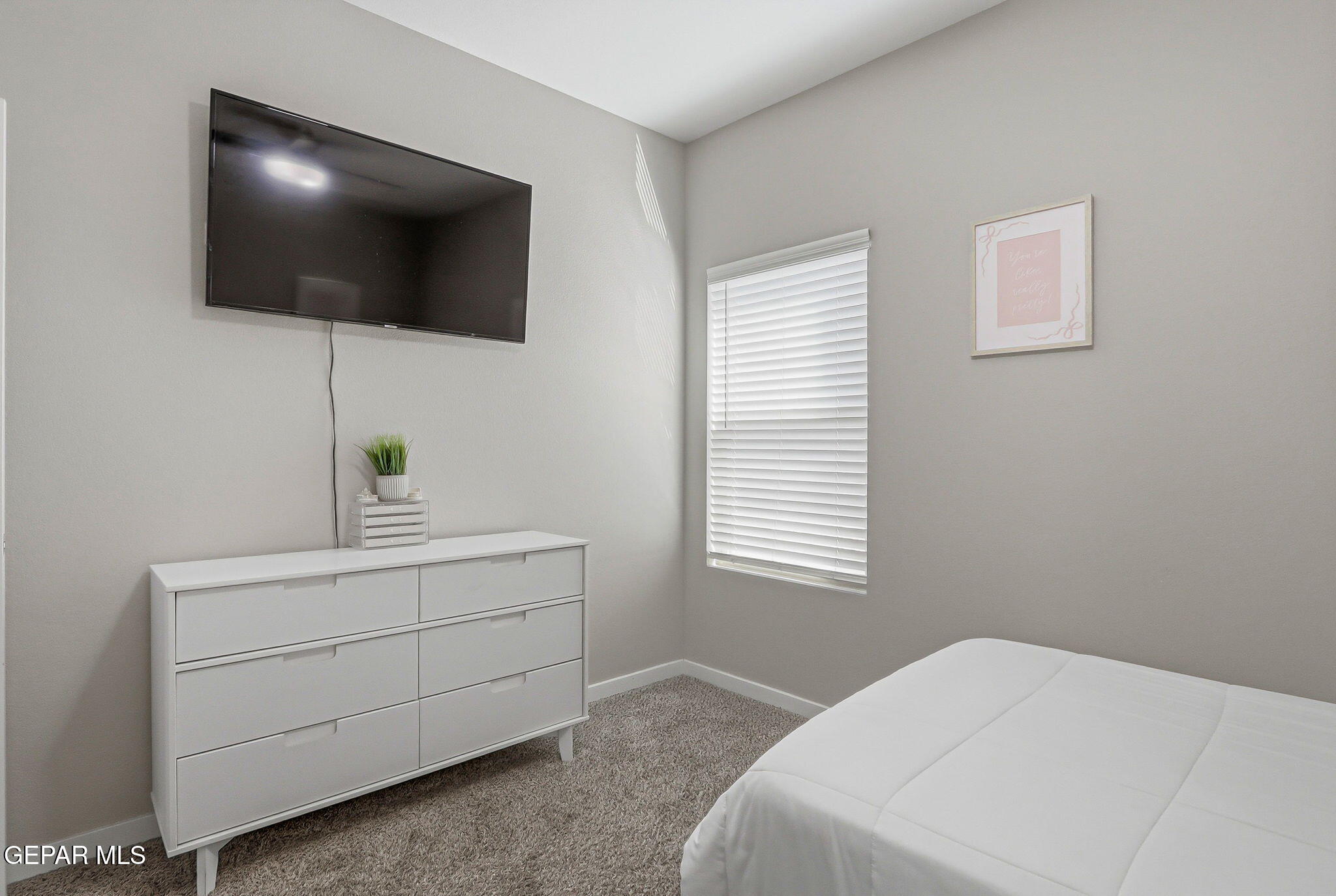 123 Via Rojas Drive Horizon City, TX 79928 - Photo 33 of 47 a bedroom with a bed and a flat screen tv