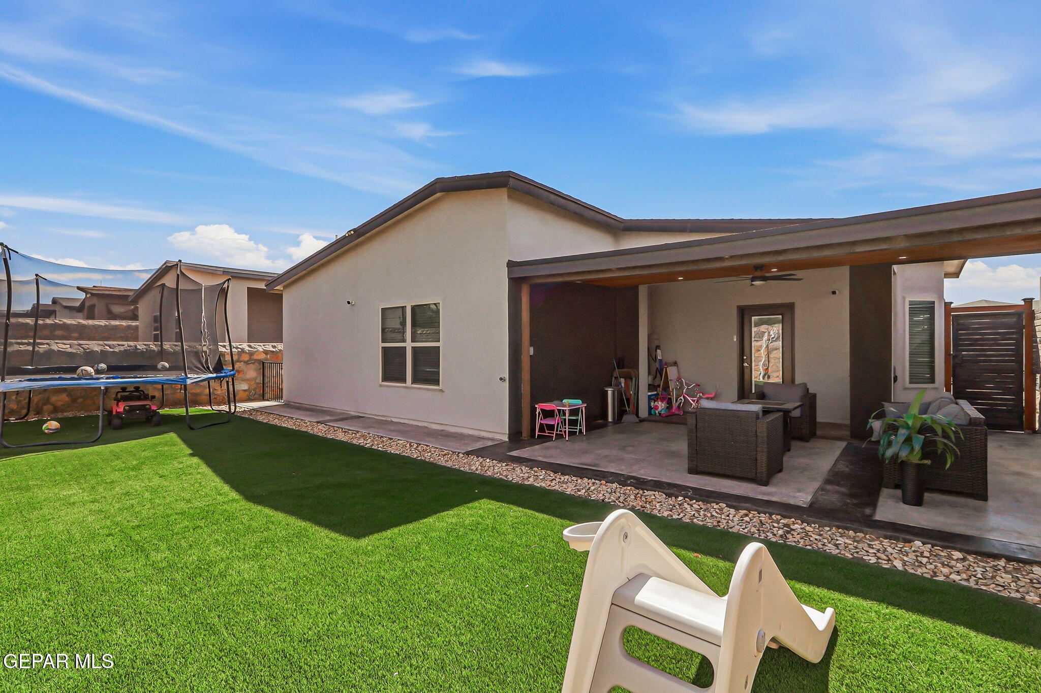 123 Via Rojas Drive Horizon City, TX 79928 - Photo 37 of 47 a view of an house with backyard porch and outdoor seating
