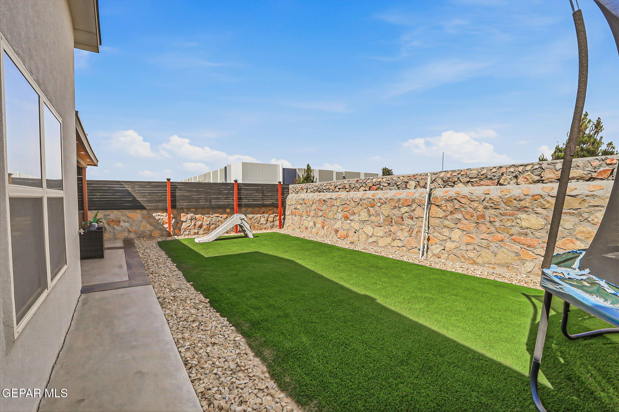 123 Via Rojas Drive Horizon City, TX 79928 - Photo 39 of 47 a view of a garden with lawn chairs