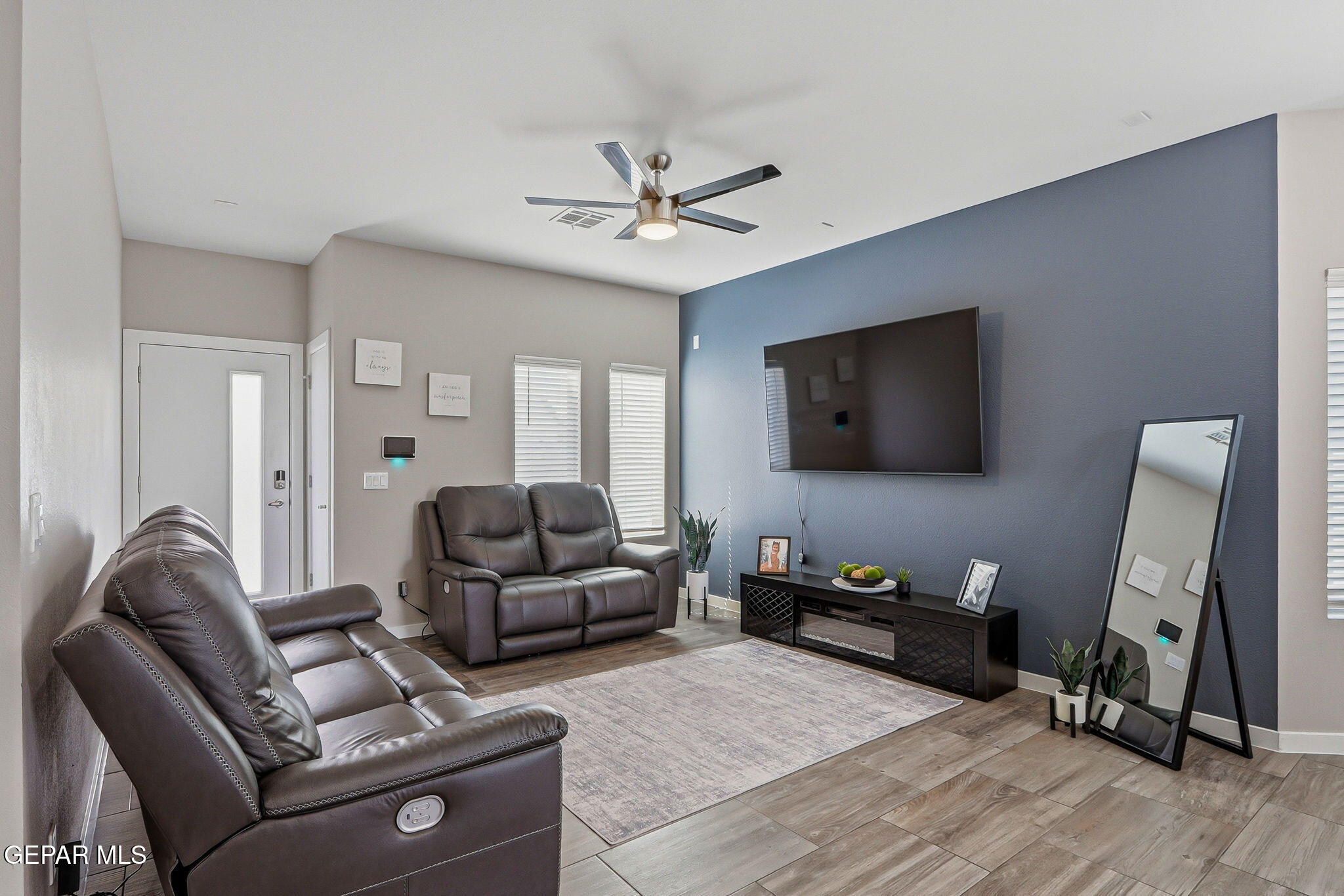123 Via Rojas Drive Horizon City, TX 79928 - Photo 10 of 47 a living room with furniture and a flat screen tv