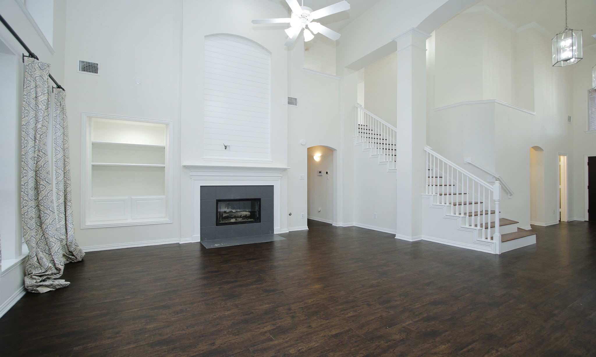 1210 Berwick Manor Court Spring, TX 77379 - Photo 18 of 50 a view of an empty room with wooden floor fireplace and a window
