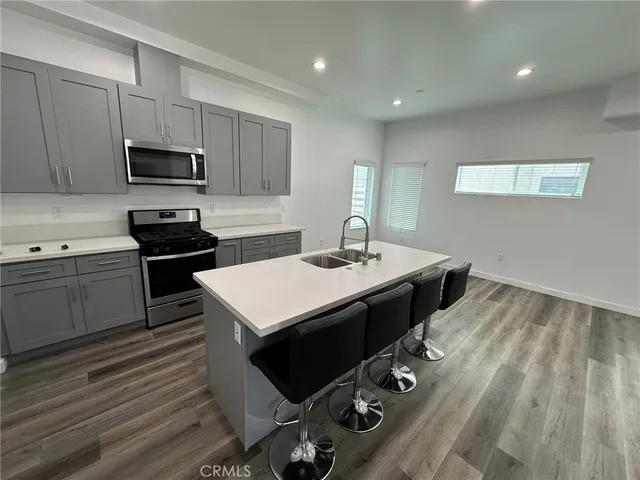 a kitchen with a sink appliances and cabinets