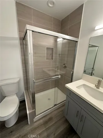 a bathroom with a granite countertop sink toilet and shower