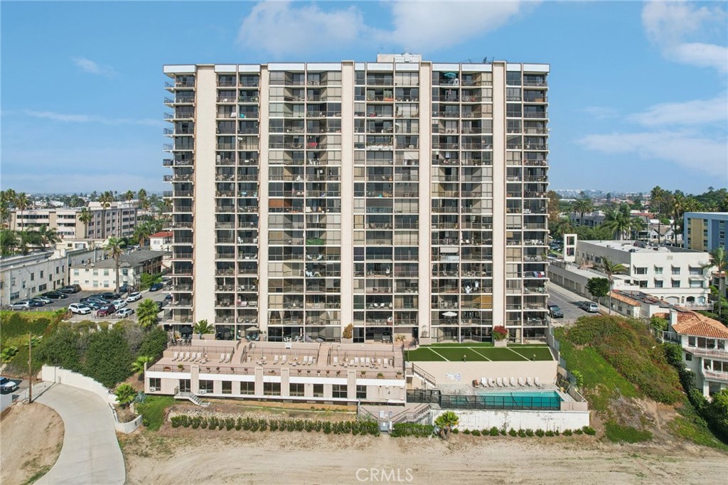 1750 East Ocean Boulevard, Unit 102 Long Beach, CA 90802 - Photo 18 of 22 a front view of a building with a garden