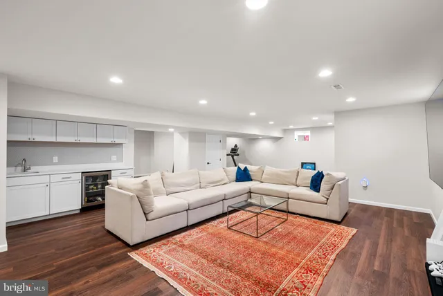 a living room with furniture and kitchen view