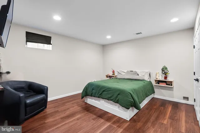 a bedroom with a bed and a couch