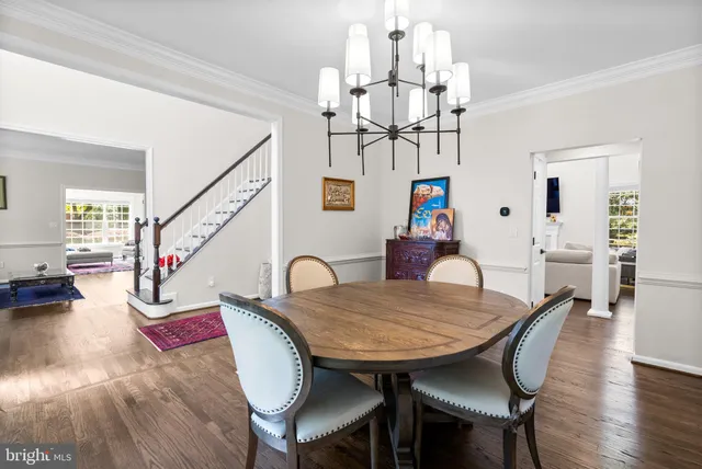 a view of a dining room with furniture wooden floor and chandelier