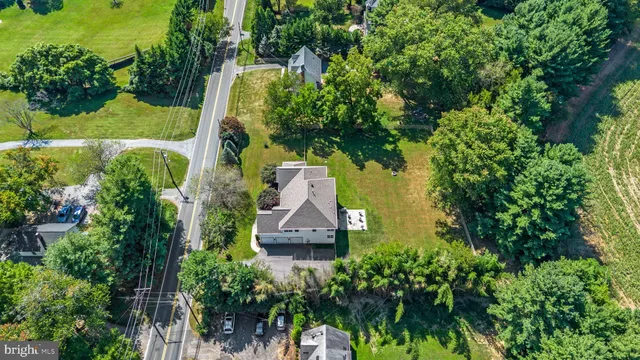 an aerial view of house with yard swimming pool and outdoor seating
