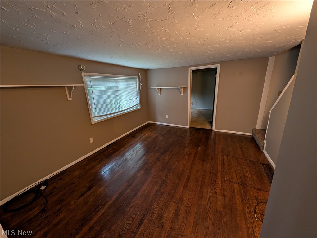 5205 Blair Road Perry, OH 44081 - Photo 4 of 10 Spacious room featuring wood-finish flooring, neutral-toned walls, and white trim