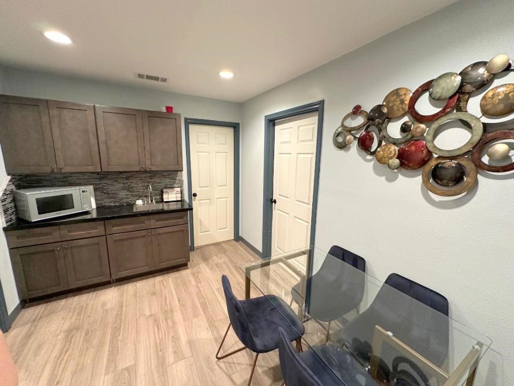 25920 Grand Pines Road Magnolia, TX 77355 - Photo 10 of 16 a kitchen with stainless steel appliances granite countertop a stove and a microwave