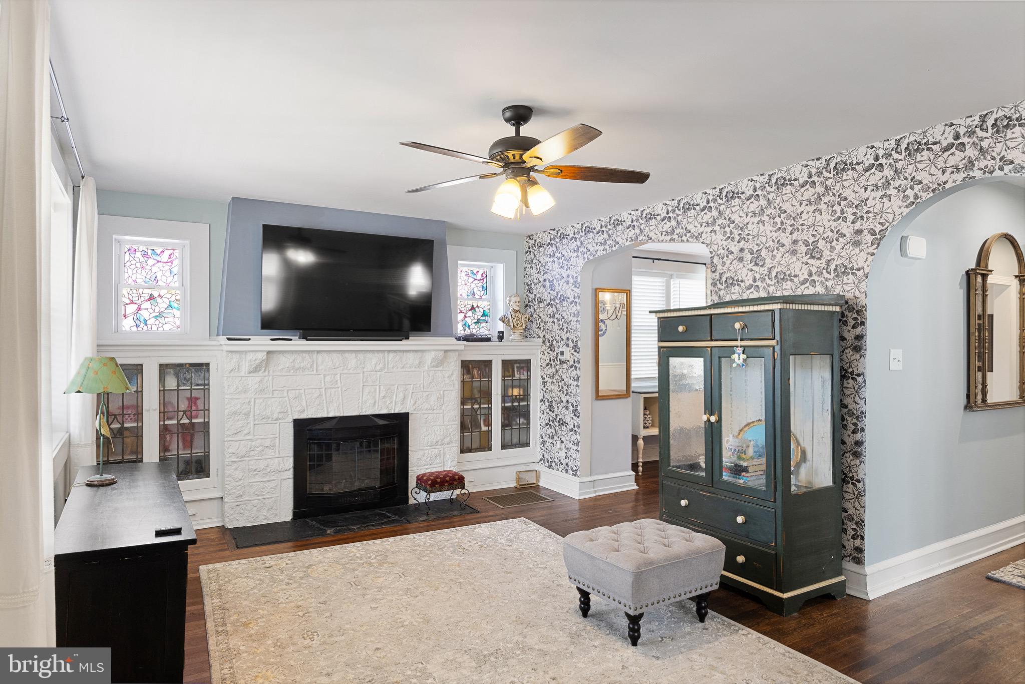 809 Amherst Road Audubon, NJ 08106 - Photo 5 of 31 a living room with furniture a fireplace and a flat screen tv