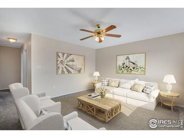 a living room with furniture a rug and a window