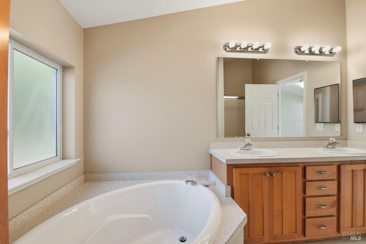 121 Coronado Circle Santa Rosa, CA 95409 - Photo 17 of 32 a bathroom with a tub sink and mirror