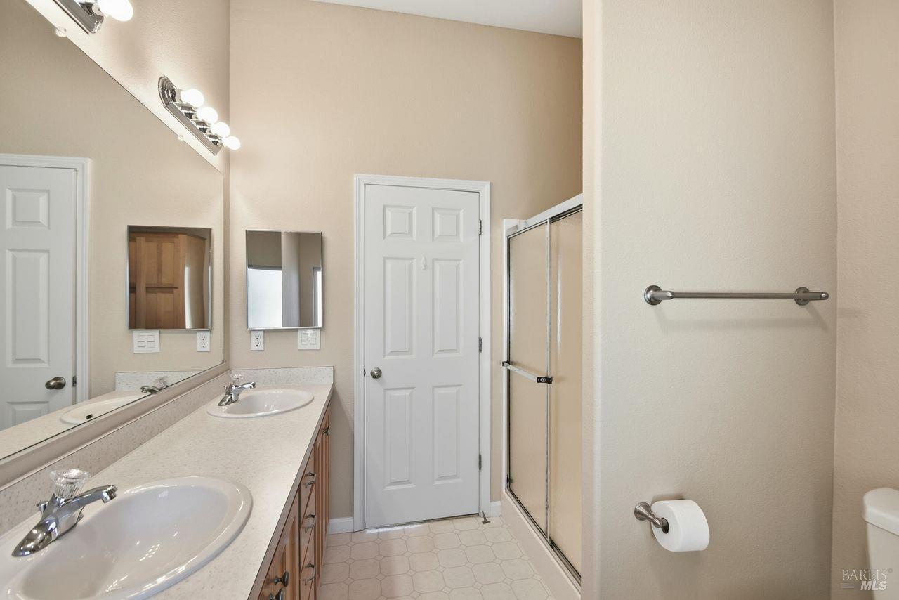 121 Coronado Circle Santa Rosa, CA 95409 - Photo 18 of 32 a bathroom with a sink double vanity granite tub and shower