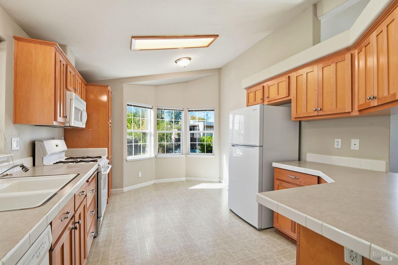 121 Coronado Circle Santa Rosa, CA 95409 - Photo 6 of 32 a kitchen with a sink a stove and a refrigerator